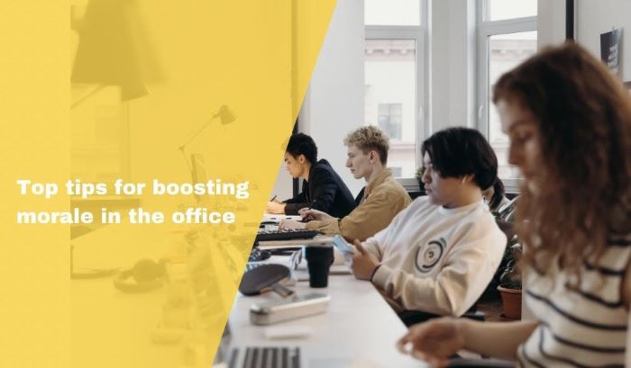 'Top tips for boosting morale in the office' written over image of four young employees at desk on computers