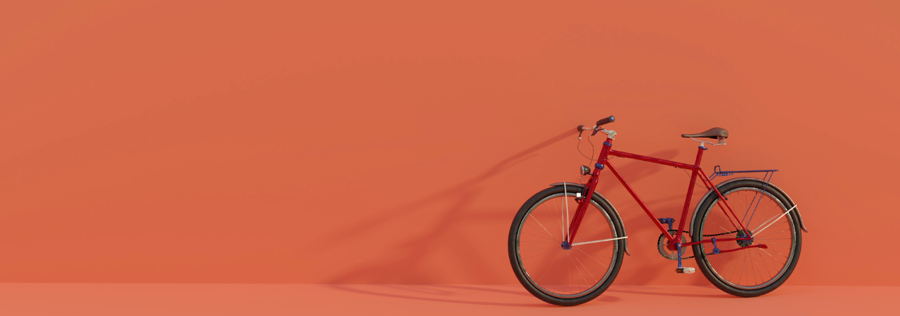 Red bike leant up against a red wall