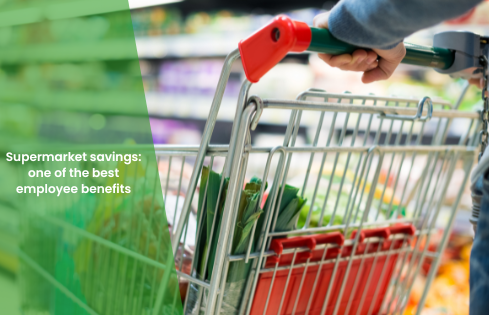 Image of shopping trolley being pushed in a supermarket with green overlay and blog title 'Supermarket savings: one of the best employee benefits'