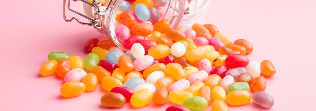 an image of jelly beans coming out of a jar