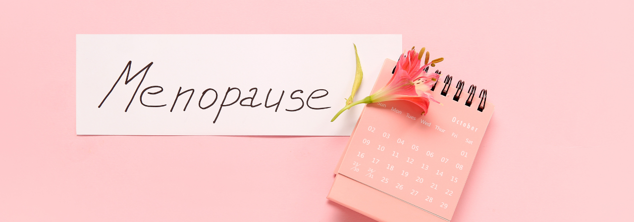 A pink background image with the title Menopause, a mall calendar and flower next to it.