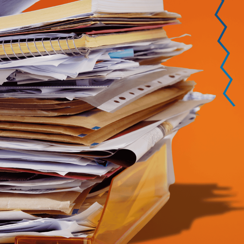 Stack of paperwork against orange background