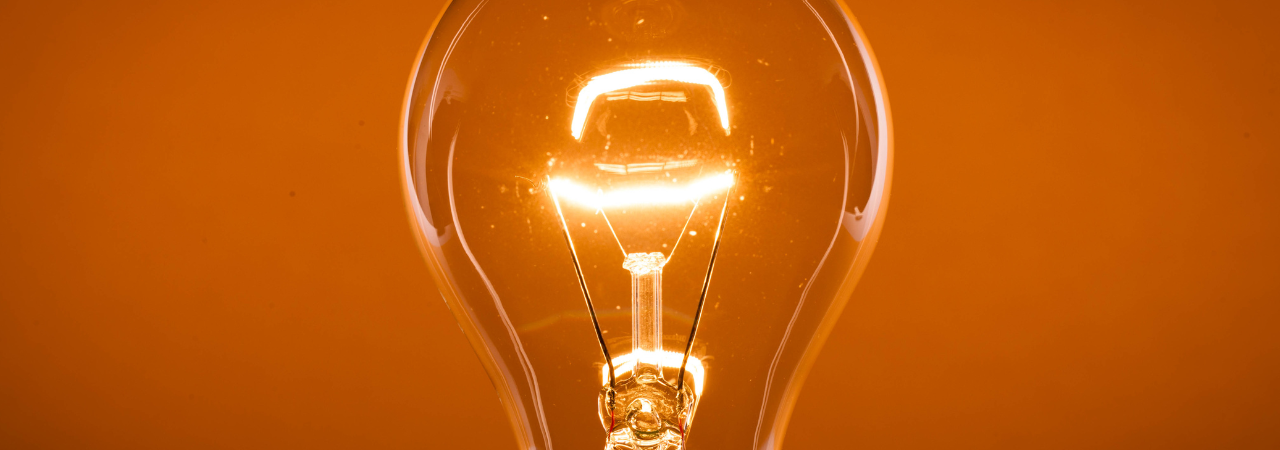 an image of an orange background with a bright bulb